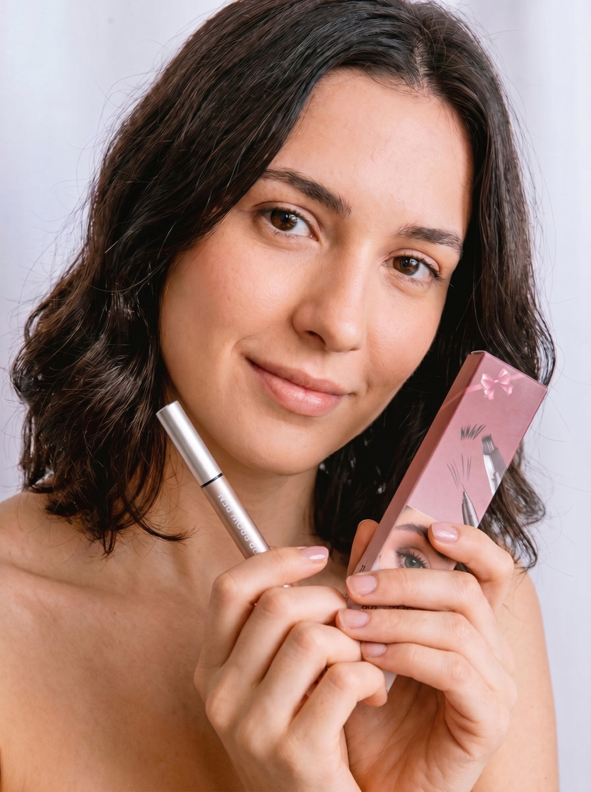 Model holding MicroBrow Brow Pen